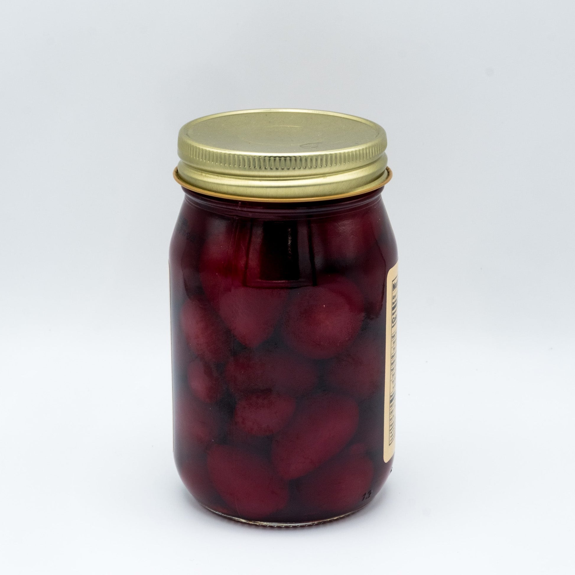 Canned Amish Country Store pickled baby beets in a 32oz jar, showing vibrant red beets immersed in pickling liquid.
