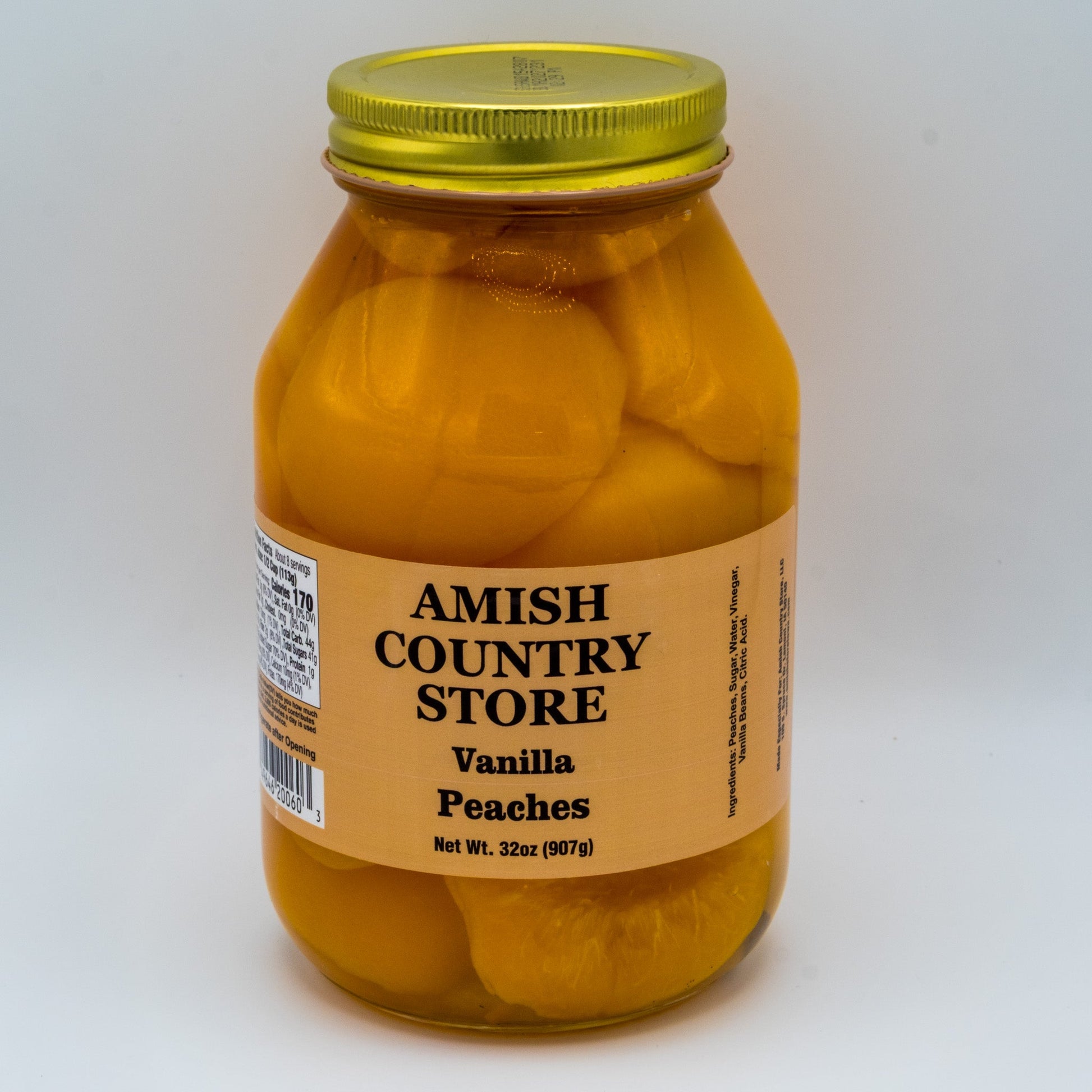 Canned vanilla peaches with real vanilla beans in a 32oz jar from Amish Country Store, showcasing the fresh fruit and vanilla bean pieces.