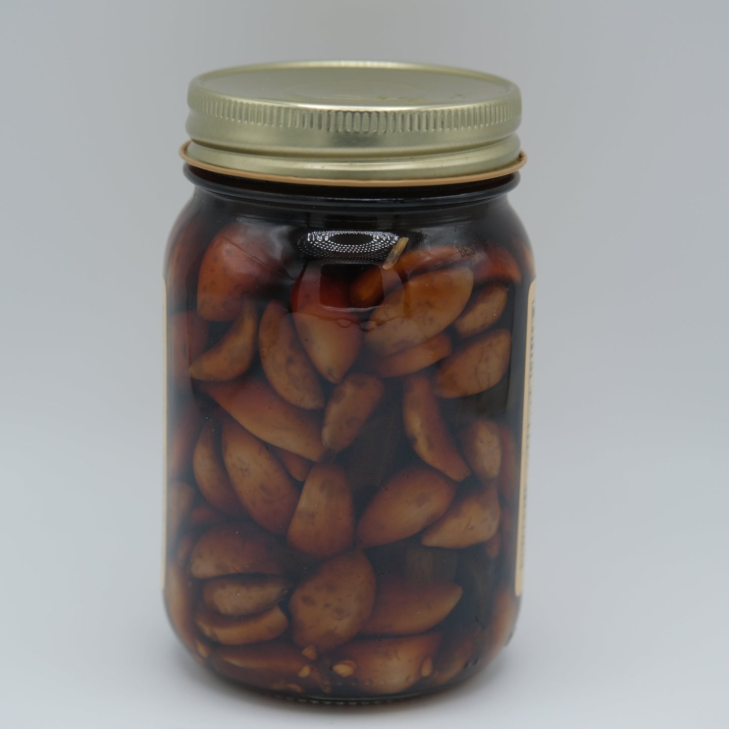 Canned Amish Country Store Spicy Asian Garlic 16oz jar with visible garlic cloves and spicy red chili peppers inside