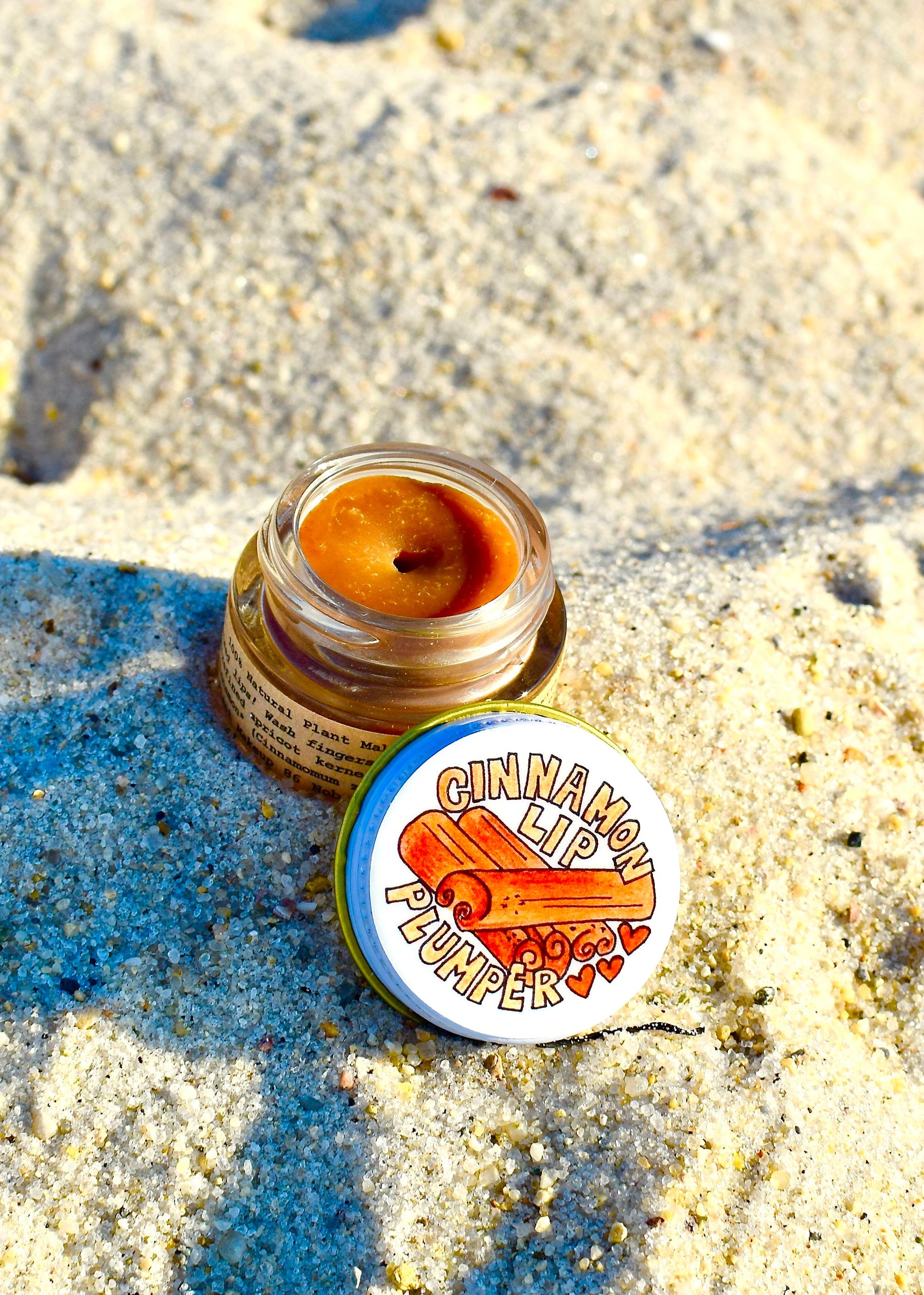 Plant Makeup Cinnamon Lip Plumper in natural light, showing glossy, plump lips with a hint of cinnamon color.
