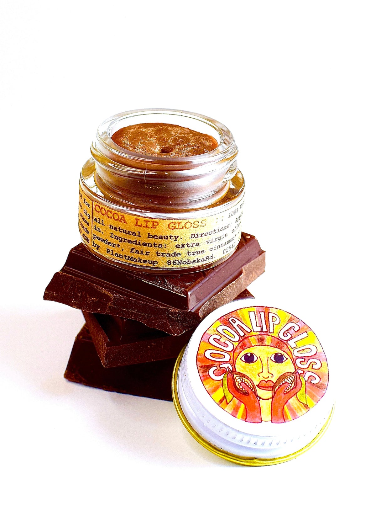 Plant Makeup Cocoa Lip Gloss tube with glossy finish and natural cocoa scent, close-up shot showing the product's packaging.