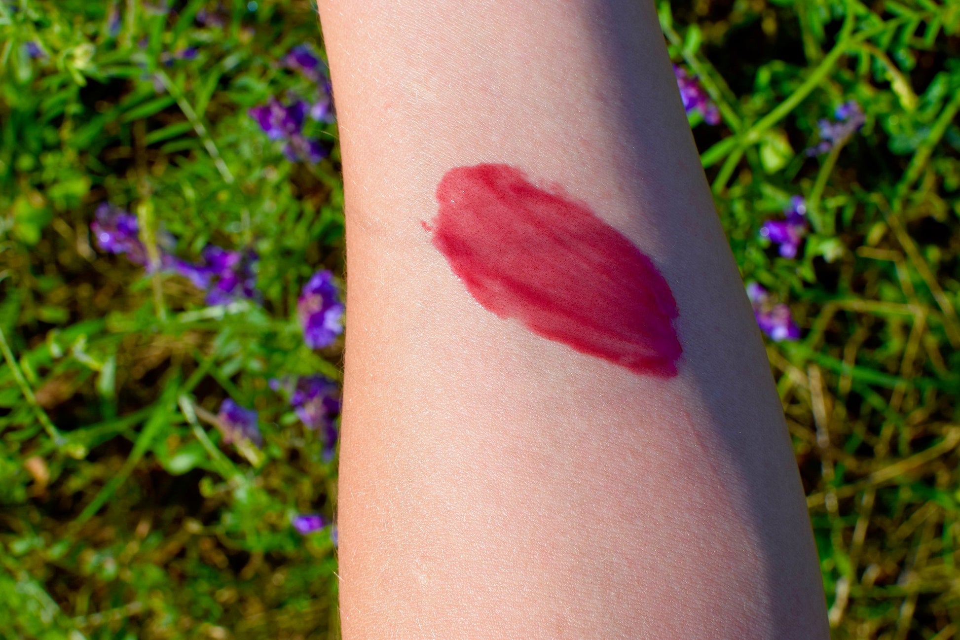 Hibiscus and beet lip tint from plant makeup, showing a close-up of the tinted lips and natural plant-based ingredients.