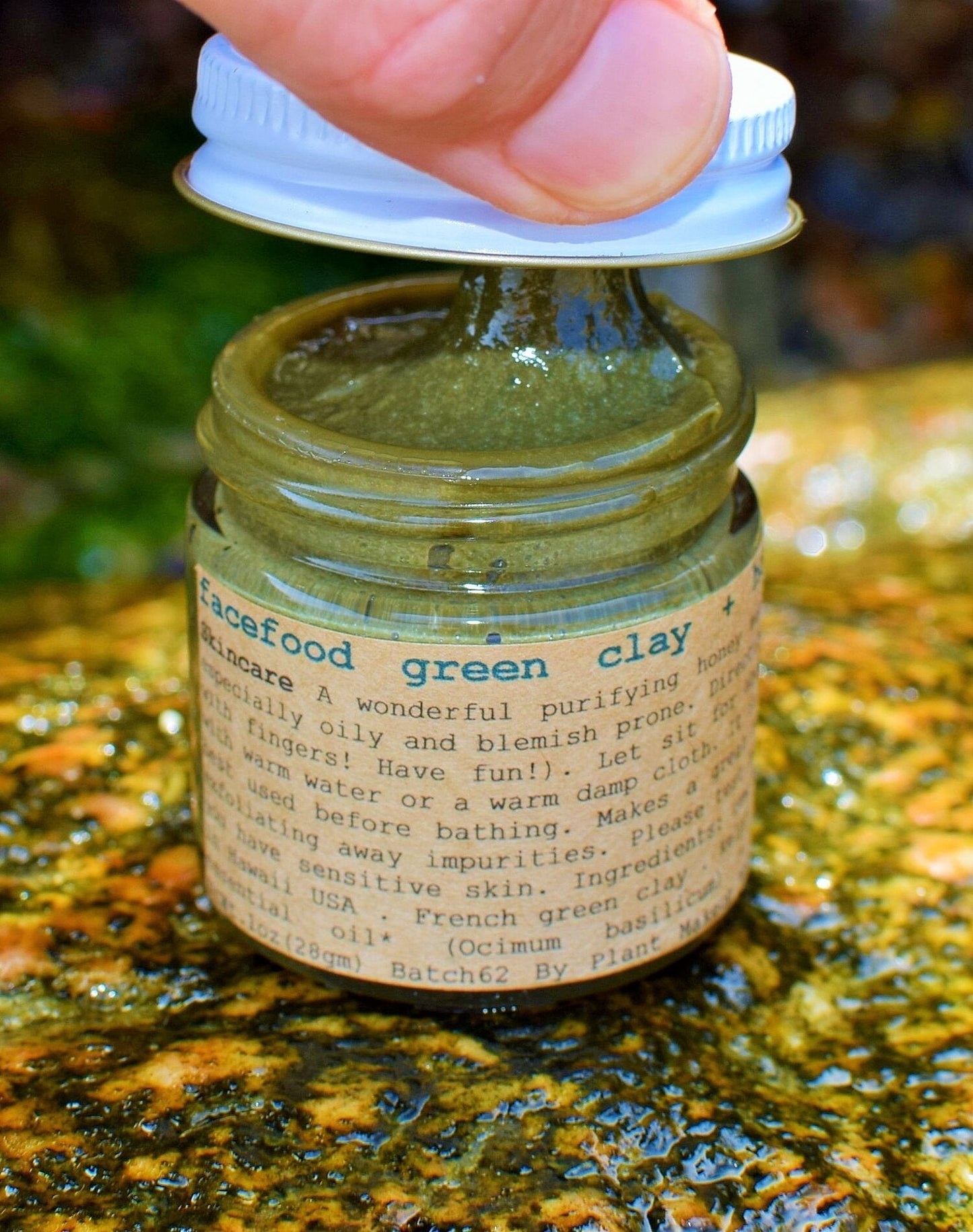 Close-up of a skincare product by Plant Makeup, featuring the Facefood skin care jar with natural ingredients visible.