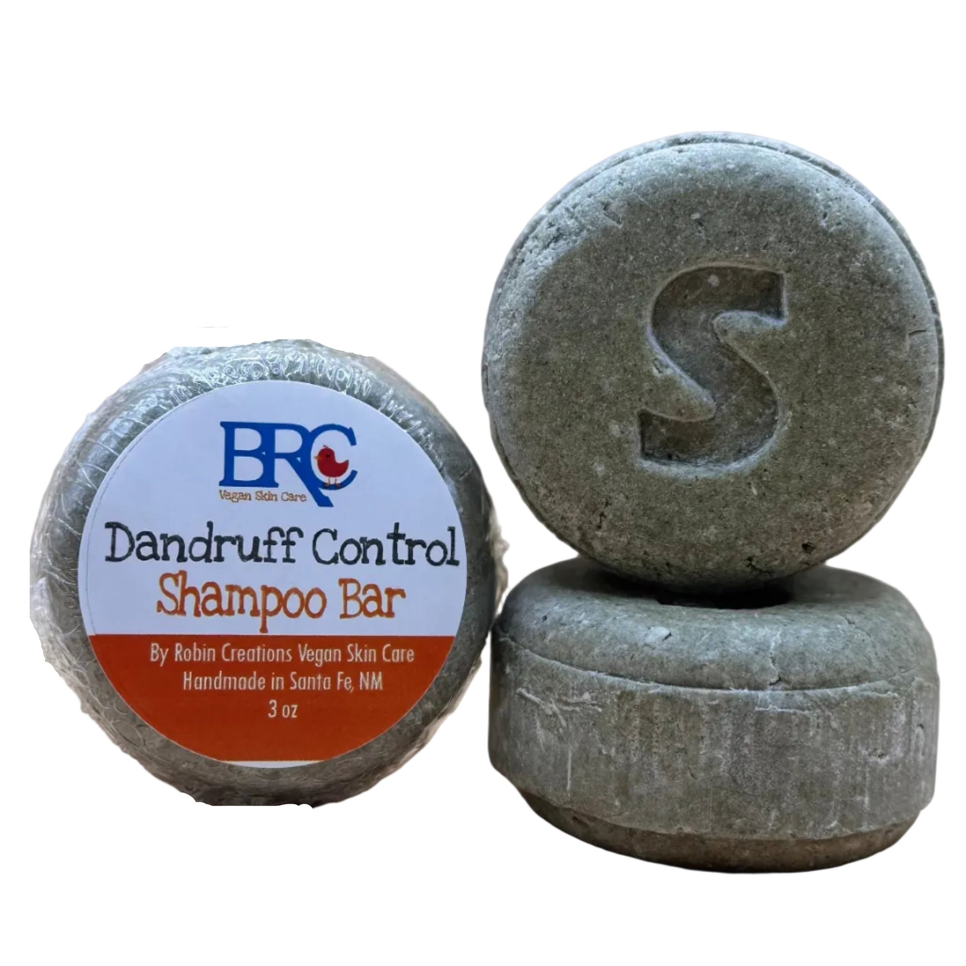 Handcrafted sulfate-free dandruff shampoo bar by By Robin Creations, showing a natural soap with a textured surface and earthy tones.