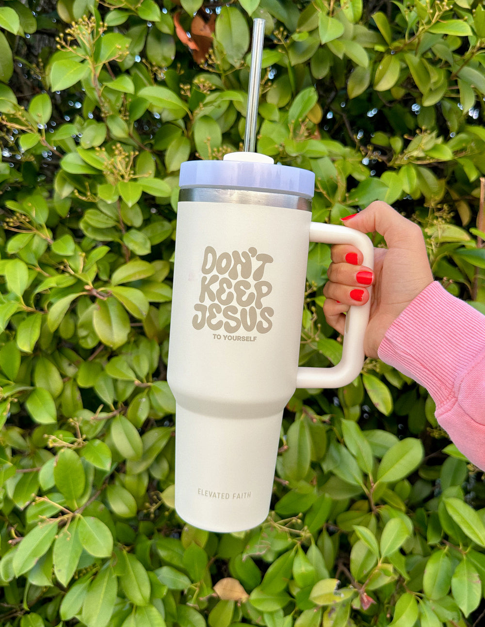 Elevated Faith 40 oz tumbler with "Don't Keep Jesus to Yourself" message, featuring a black body and stainless steel lid.