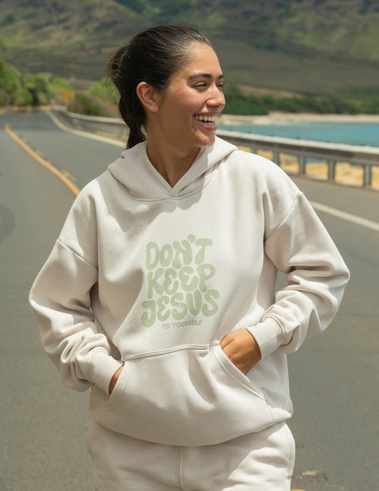 Unisex hoodie by Elevated Faith featuring the "Don't Keep Jesus to Yourself" design, shown in a comfortable, casual fit.
