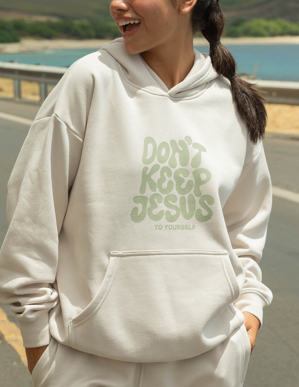 Unisex hoodie by Elevated Faith featuring the "Don't Keep Jesus to Yourself" design, displayed in a casual fit on a model.