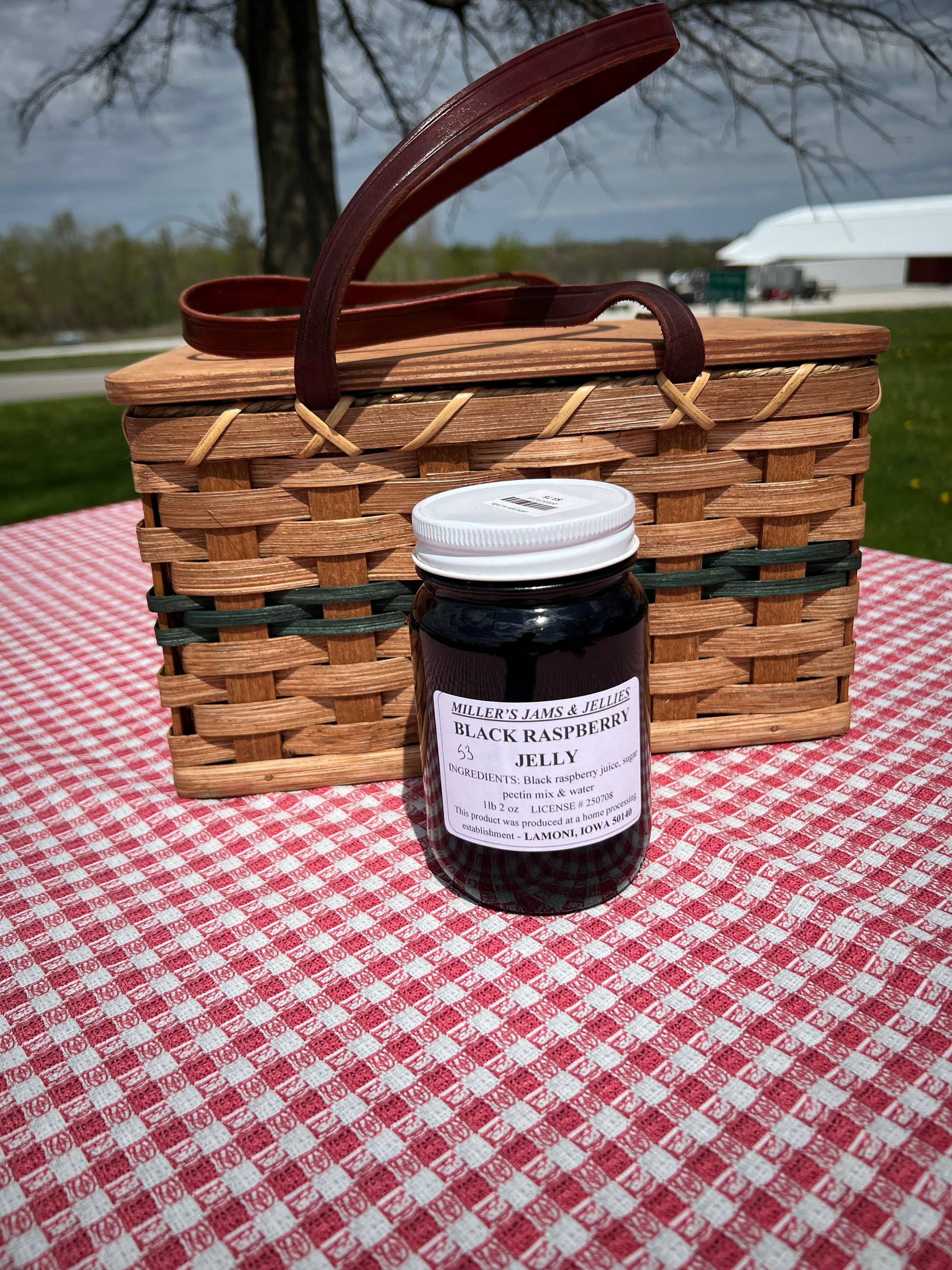 Amish Country Store black raspberry jam jar showing the label and jam inside, made by Amish artisans.