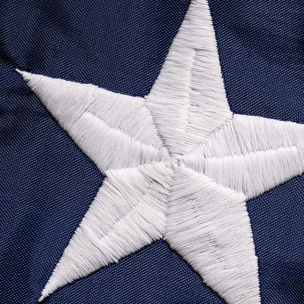 American flag made of polyester by Flagman of America, featuring embroidered stars and stripes in a patriotic design.