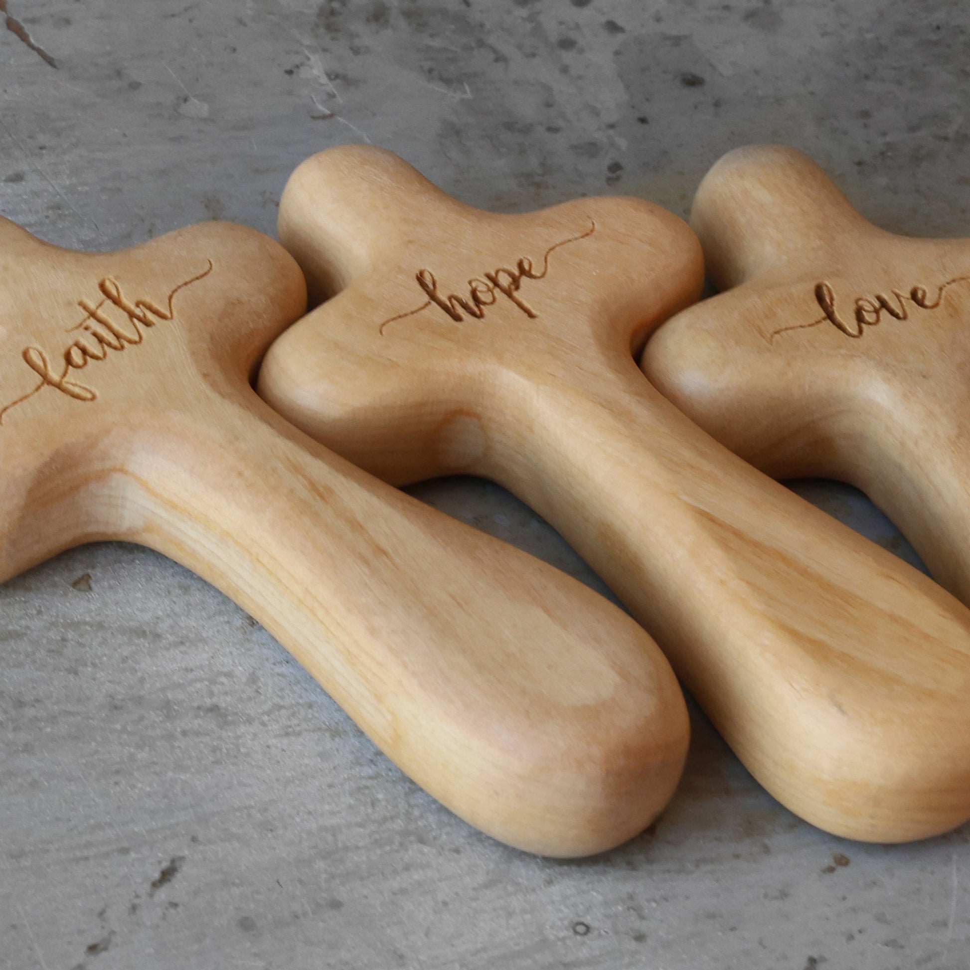 Wooden engraved prayer cross from Dennehey Design Co., featuring intricate designs and craftsmanship, representing faith and devotion.