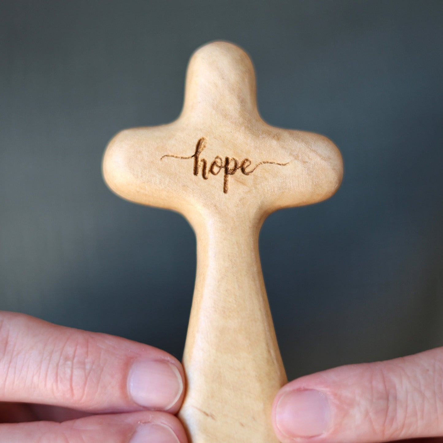 Wooden engraved prayer crosses from Dennehey Design Co., featuring detailed carvings and religious inscriptions.