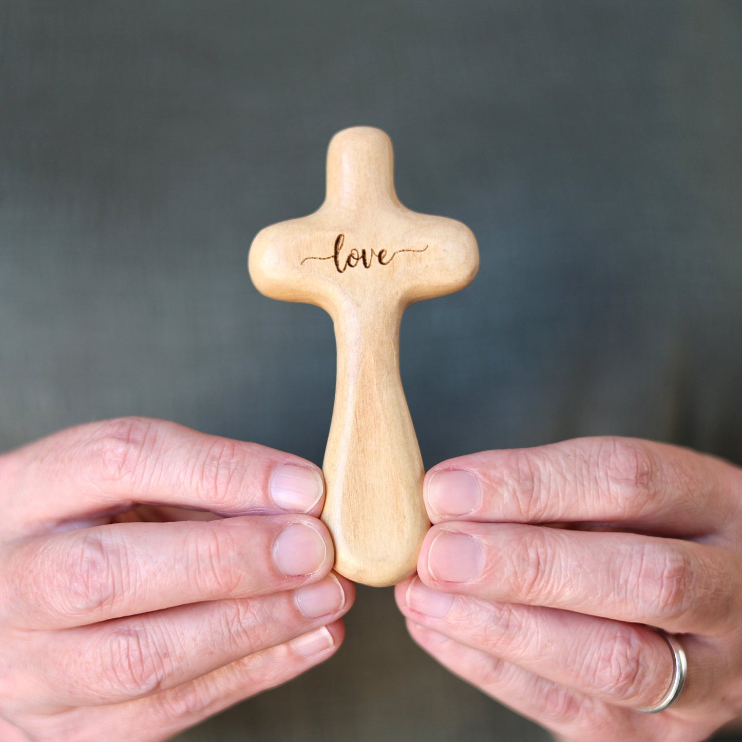 Wooden engraved prayer cross from the Holy Land by Dennehey Design Co., featuring intricate carvings and a polished finish.