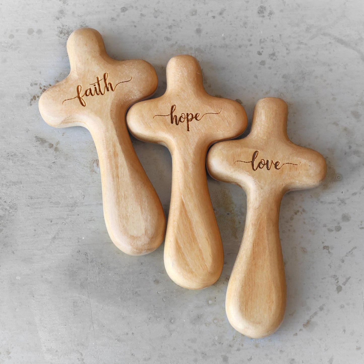 Wooden engraved prayer crosses from the Holy Land by Dennehey Design Co., featuring detailed cross designs on smooth wood surfaces.