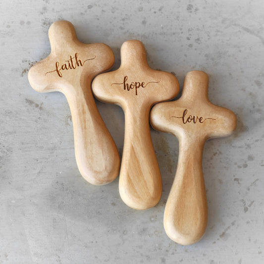Wooden engraved prayer crosses from the Holy Land by Dennehey Design Co., featuring detailed cross designs on smooth wood surfaces.