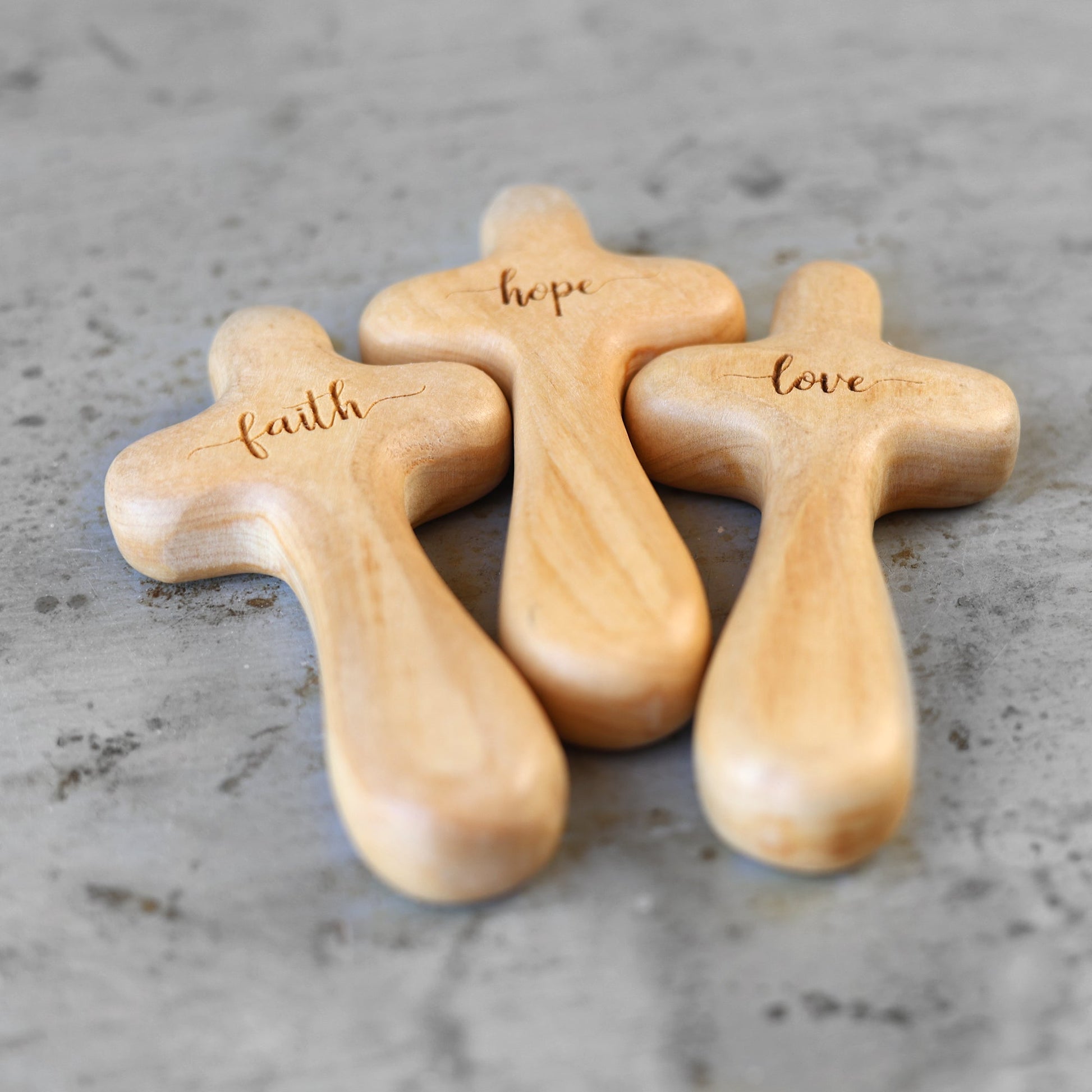 Wooden engraved prayer crosses from the Holy Land by Dennehey Design Co., featuring detailed religious carvings.