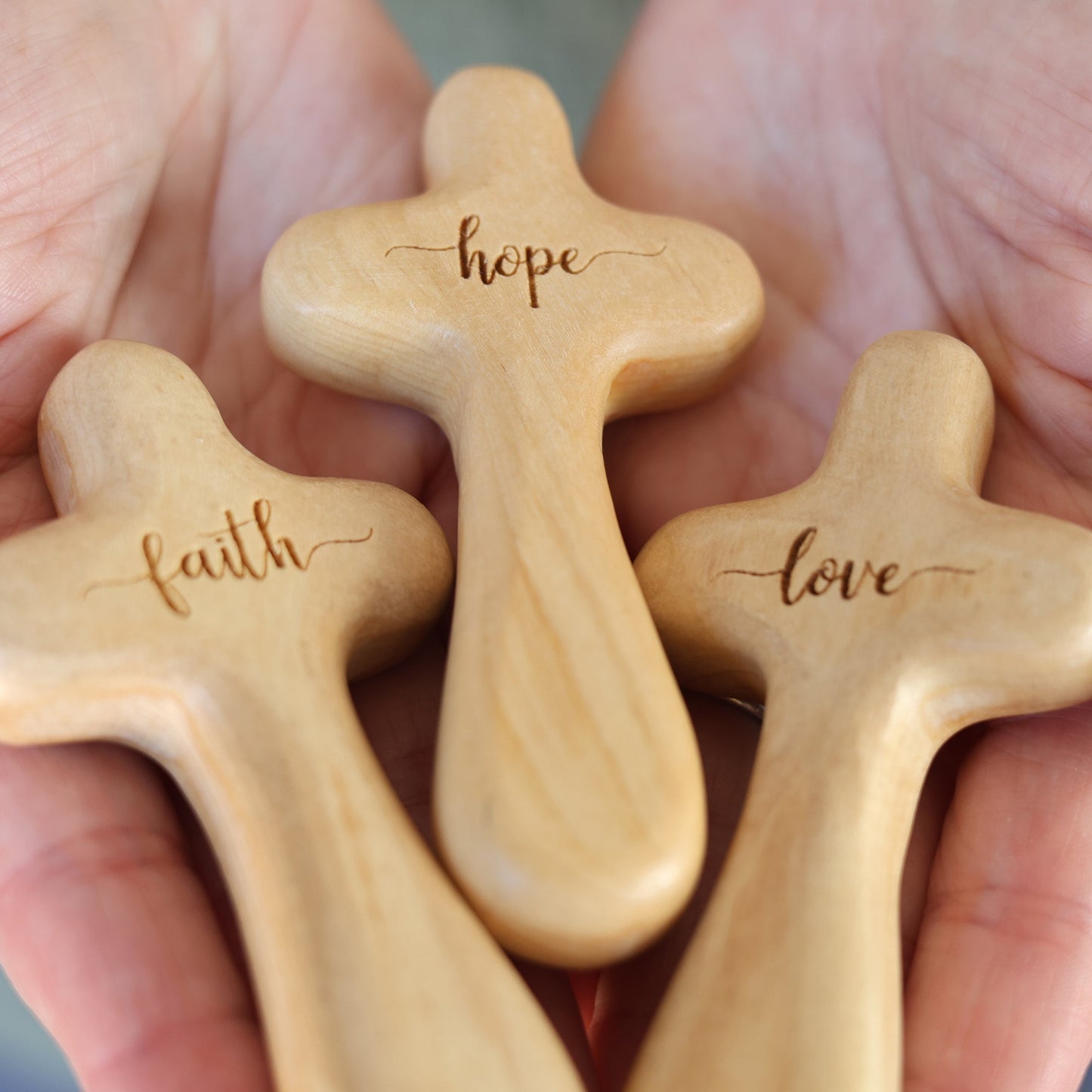Wooden engraved prayer cross from Dennehey Design Co., featuring intricate carvings and religious symbols from the Holy Land.