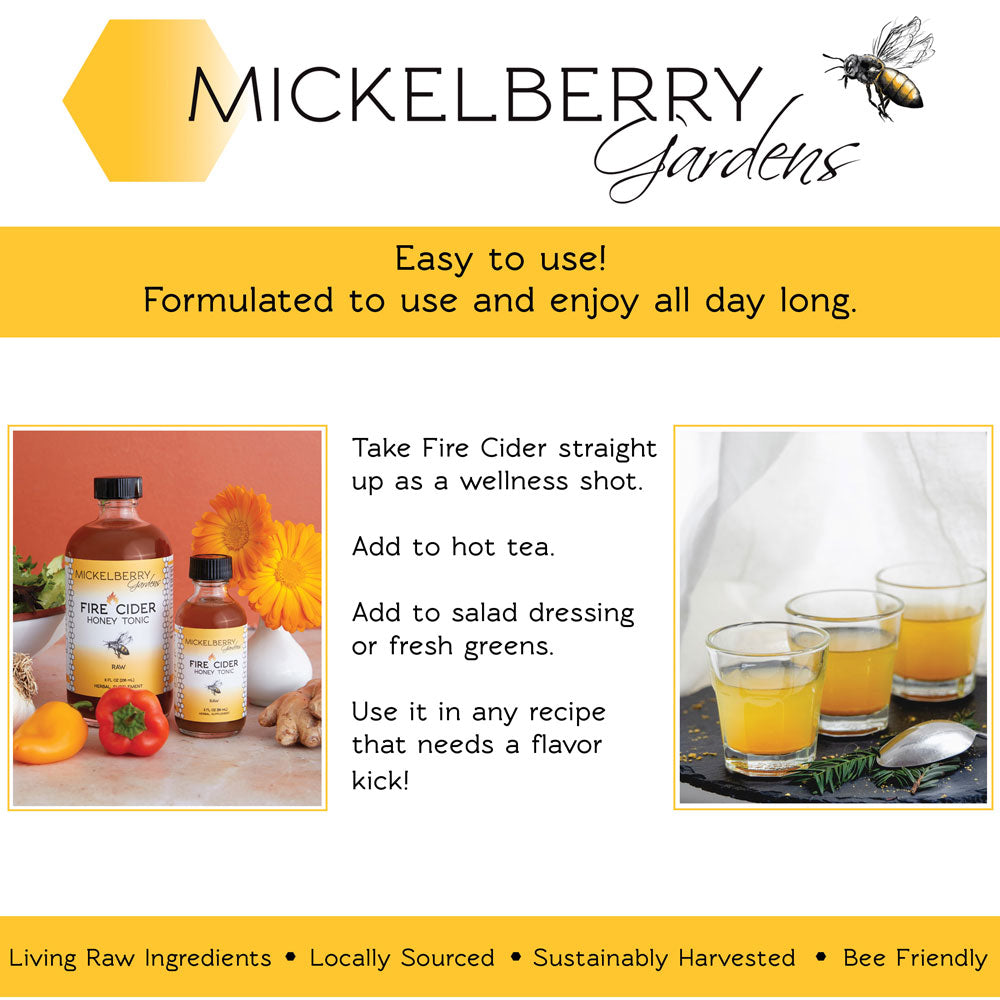 Bottle of Mickelberry Gardens Fire Cider Honey Tonic with honey and herbal ingredients in a clear glass bottle on a wooden surface.