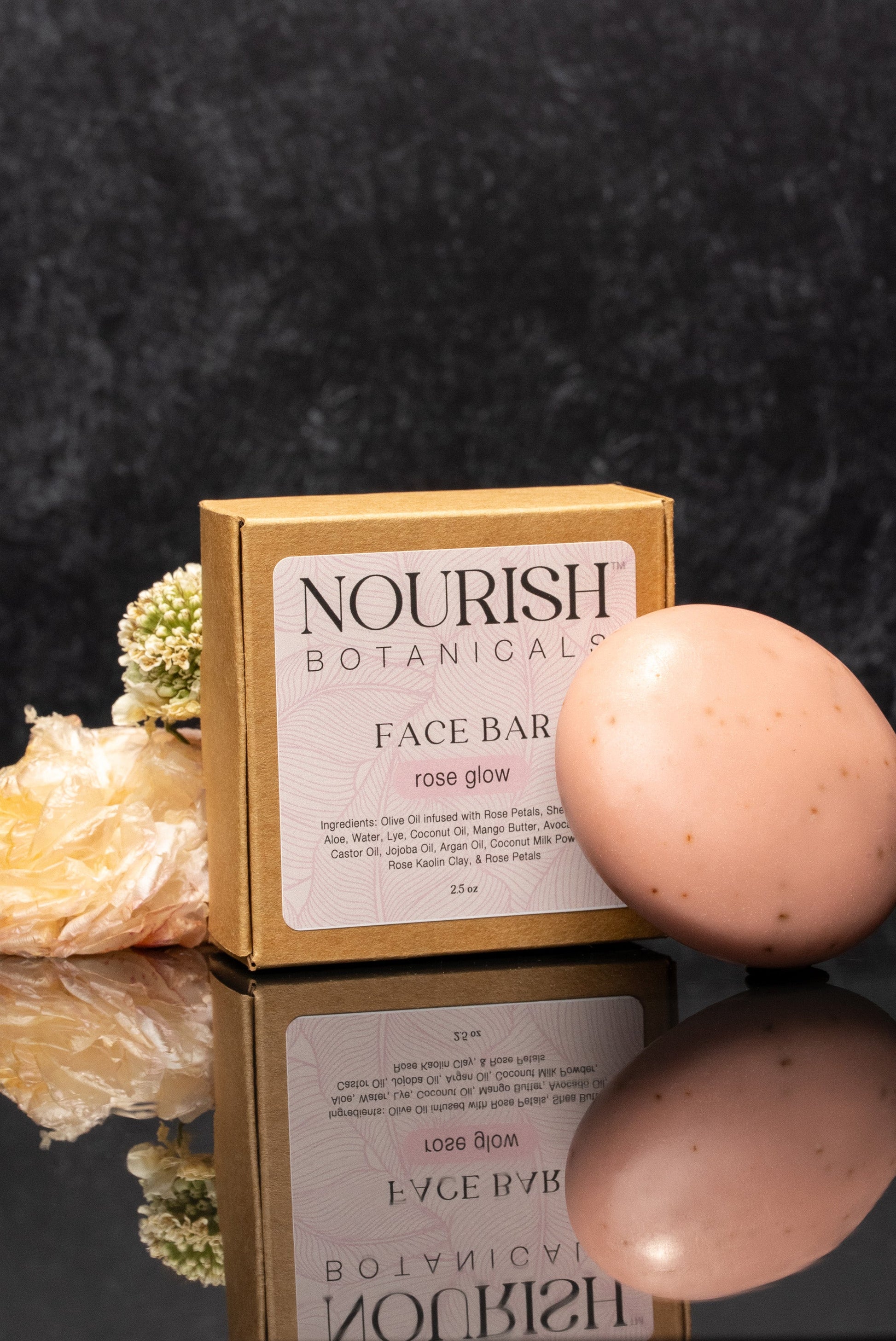 Rustic Strength Rose Glow face bar soap, 2.5 oz, with a pinkish hue and floral scent, shown in a close-up image.