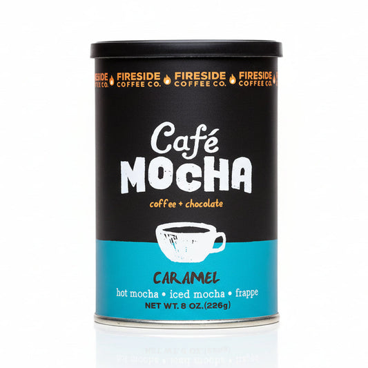 Fireside Coffee Co. caramel cafe mocha in a clear glass mug with whipped cream and caramel drizzle, ready to enjoy.