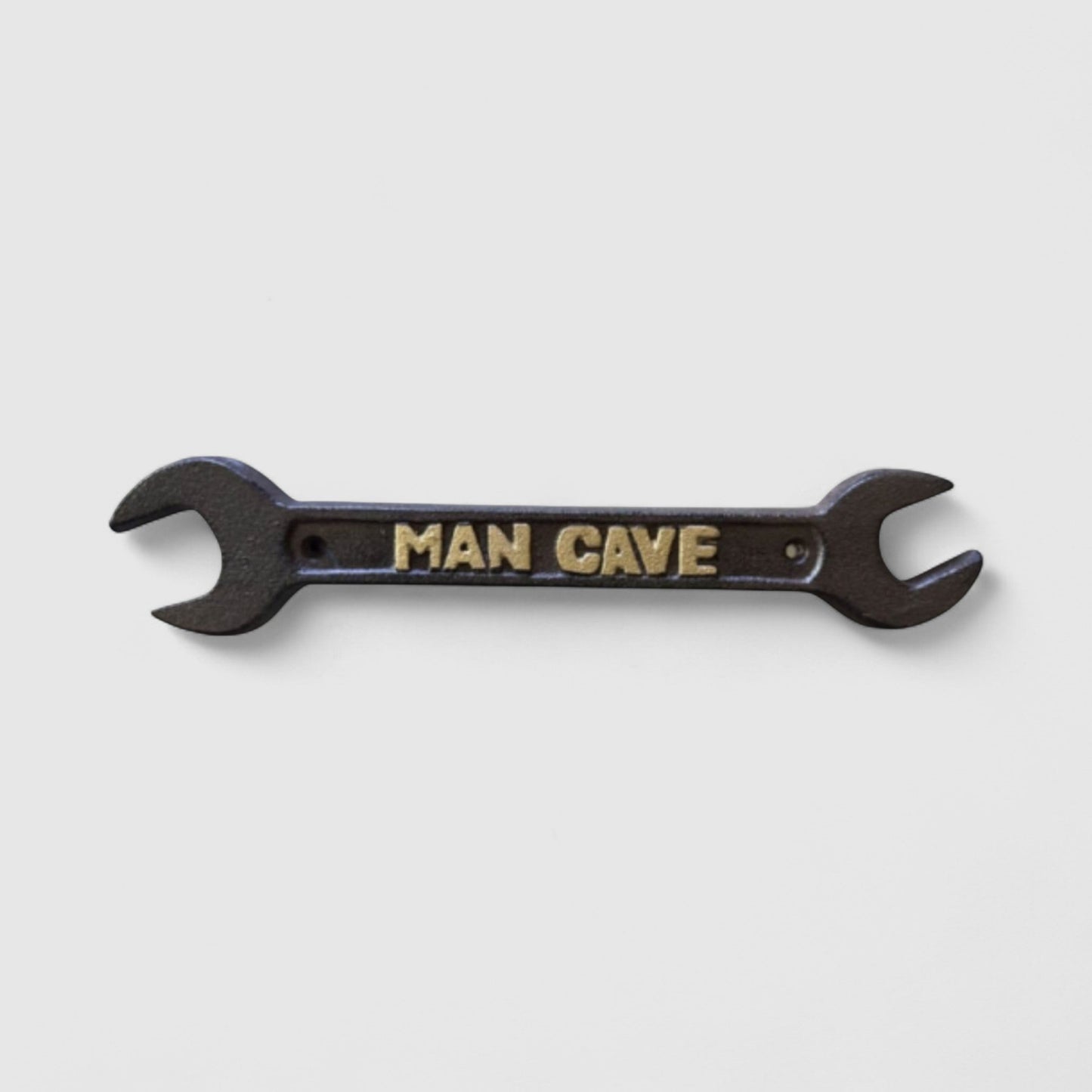 Iron & Blossom cast iron spanner wrench man cave plaque featuring rugged industrial decor with a vintage wrench design.
