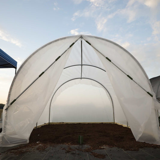 Bootstrap Farmer scissor door kit installed on a hobby greenhouse, showcasing easy access and durable construction for gardening projects.