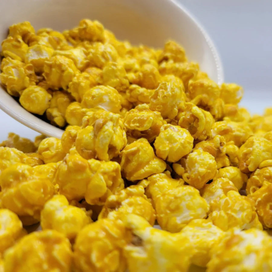 Banana flavored popcorn in a 7 oz bag from HR Poppin' Snacks, featuring colorful packaging and fresh popcorn inside.