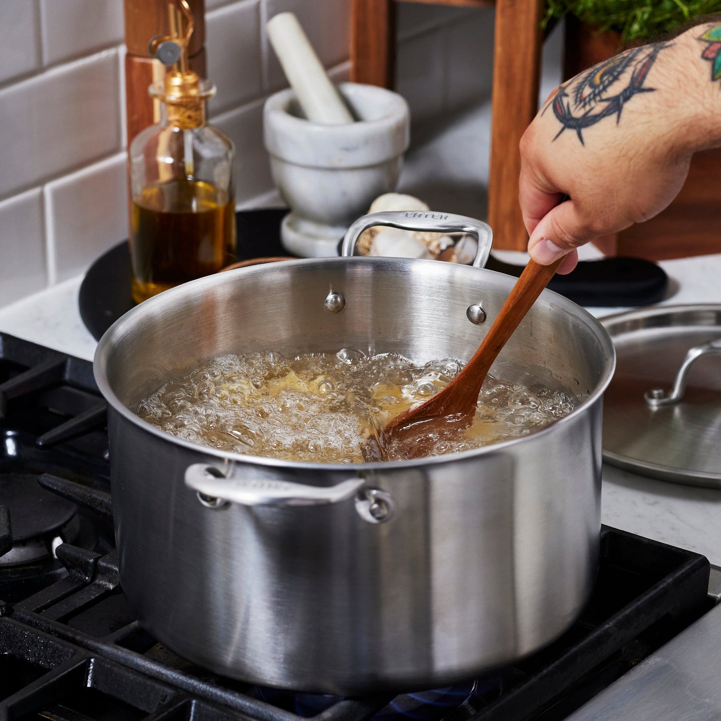 Heritage Steel Eater 8 Quart stock pot with lid, durable stainless steel cookware for soups and stews, shown with lid on.