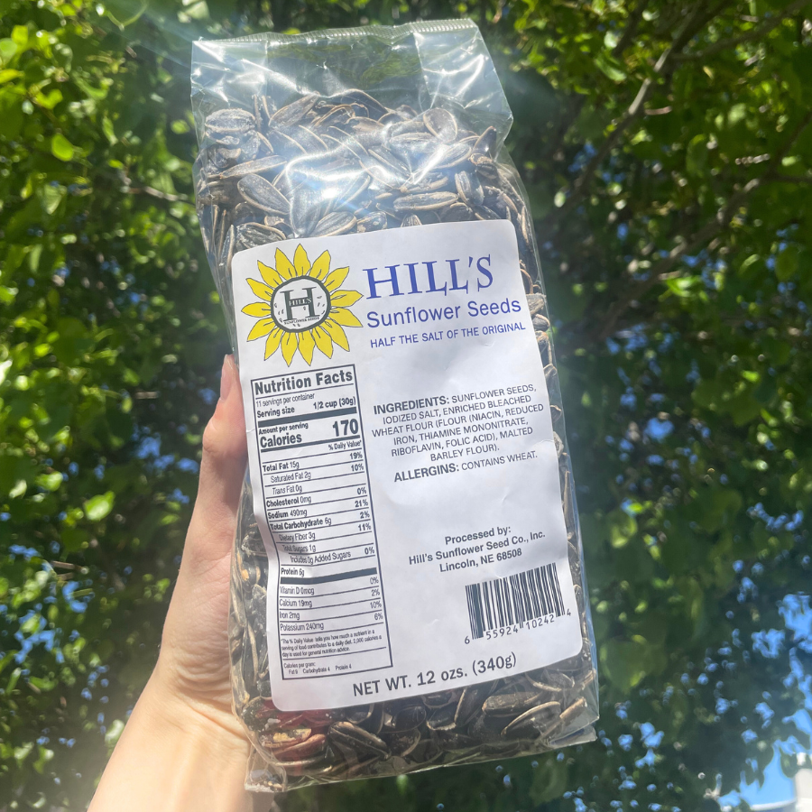 Half Salt sunflower seeds in a 12 oz multipack by Hill's Sunflower Seeds, displayed in a clear bag with seeds visible.