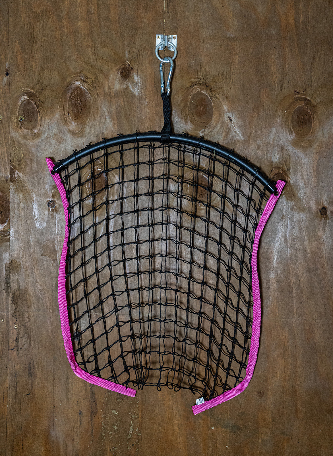 Limited edition hot pink haynet from Haylo Haynets, LLC, featuring a durable, tightly woven design for horse feed storage.