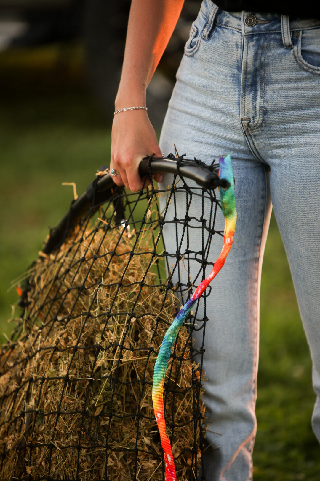 Colorful tie-dye haynet from Haylo Haynets, LLC, featuring vibrant patterns and durable mesh for horse feeding.