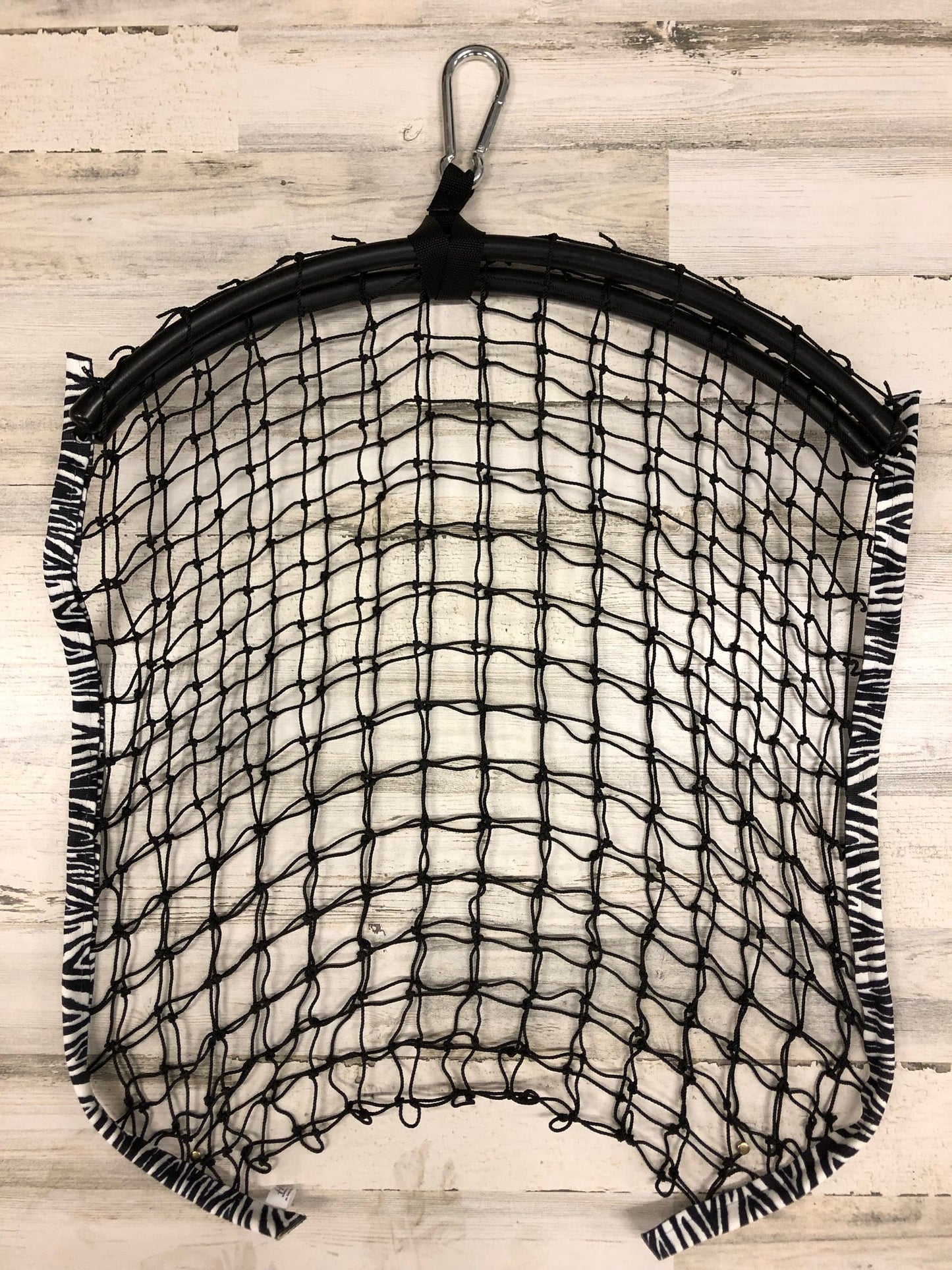 Limited edition zebra-patterned haynet from Haylo Haynets, LLC, showing a close-up of the durable mesh and vibrant zebra design.