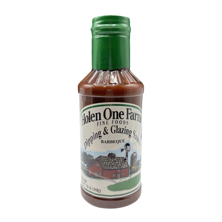 Assorted Holen One Farms barbecue marinade, sauce, and seasoning set in glass jars on a wooden surface.