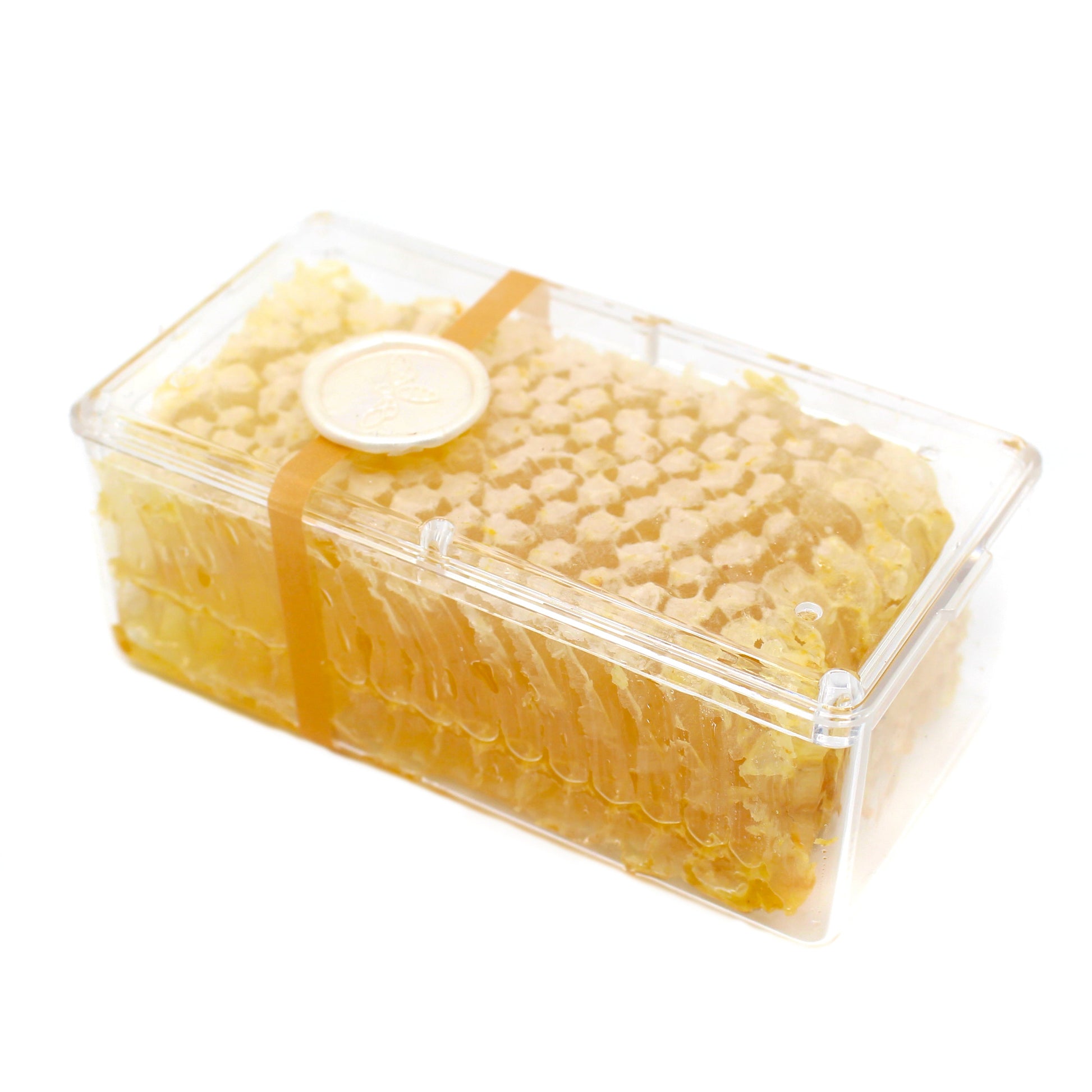 Raw honeycomb from BannerBee Company LLC, showing golden honey-filled beeswax cells in a 6oz piece.