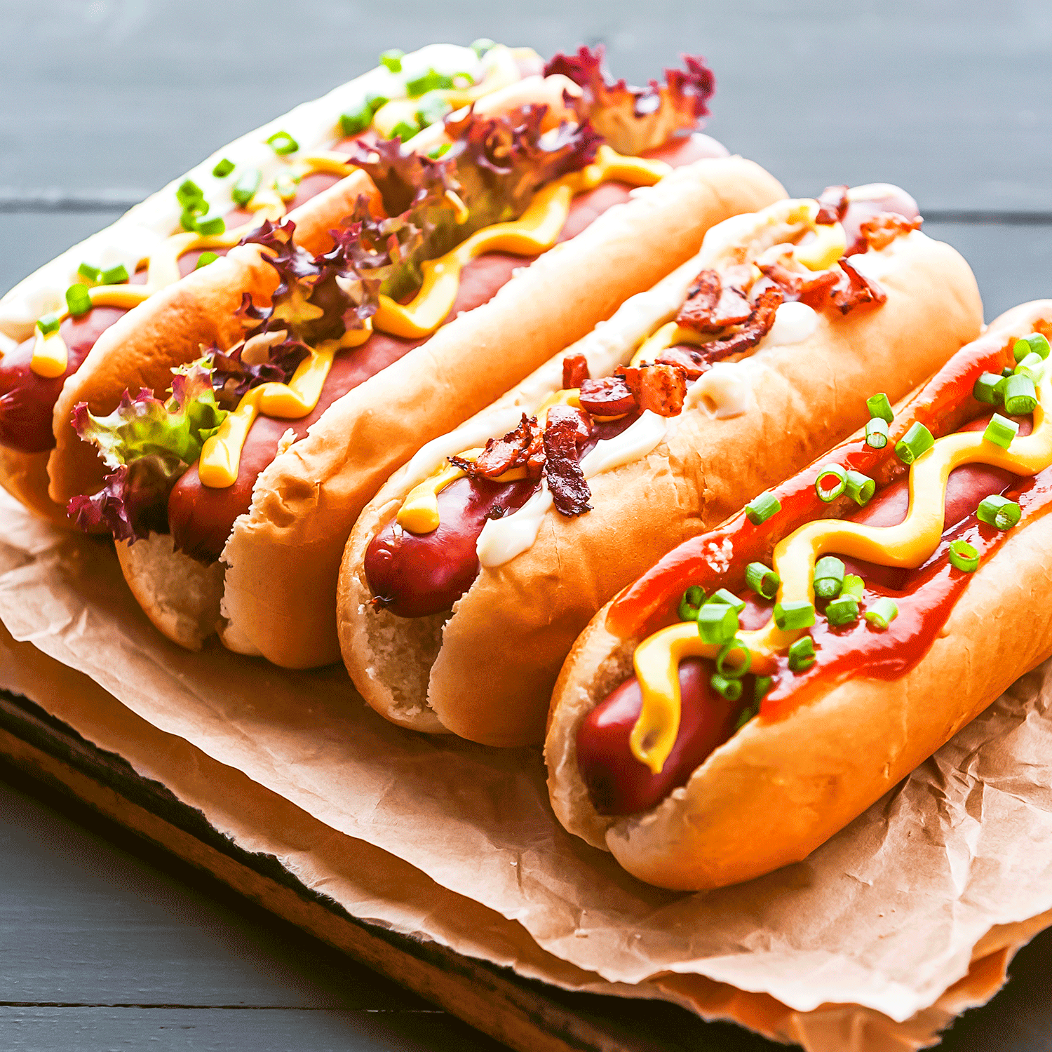 Jumbo grass-fed beef hot dogs from Pig of the Month BBQ topped with condiments and served in a bun.