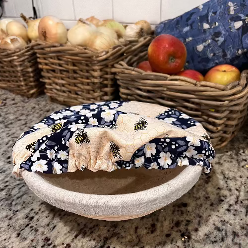 Small bowl and banneton covers from Five Oaks Farm, featuring rustic fabric and natural materials for bread proofing.