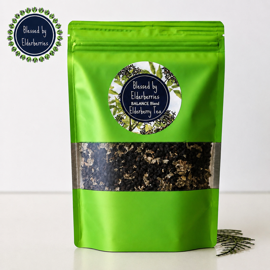 Blessed by Elderberries Balance Blend Elderberry tea in a cup with a tea bag, showcasing vibrant berry color and fresh ingredients.