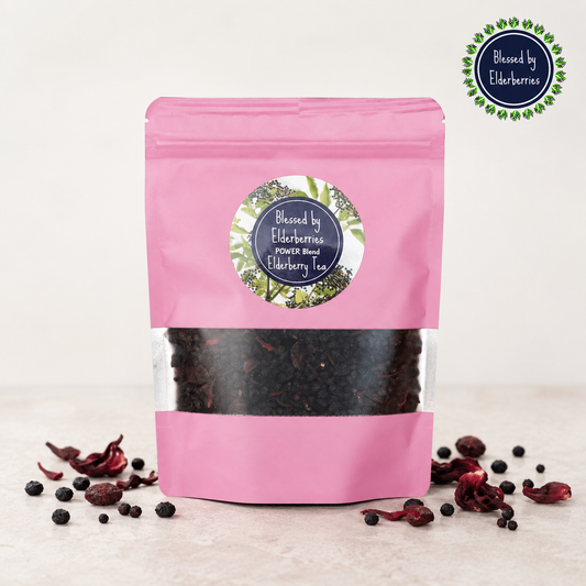 Blessed by Elderberries Power Blend Elderberry Tea in a cup with tea leaves and elderberries, showcasing a natural tea infusion.