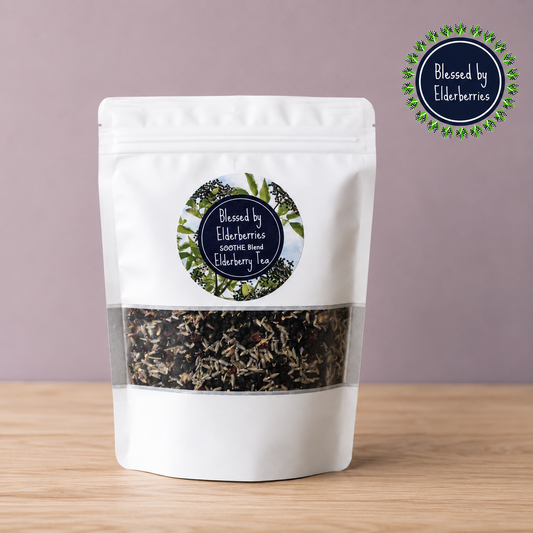 Blessed by Elderberries Soothe Blend Elderberry Tea in a tea cup with elderberries and herbs visible, promoting wellness and comfort.