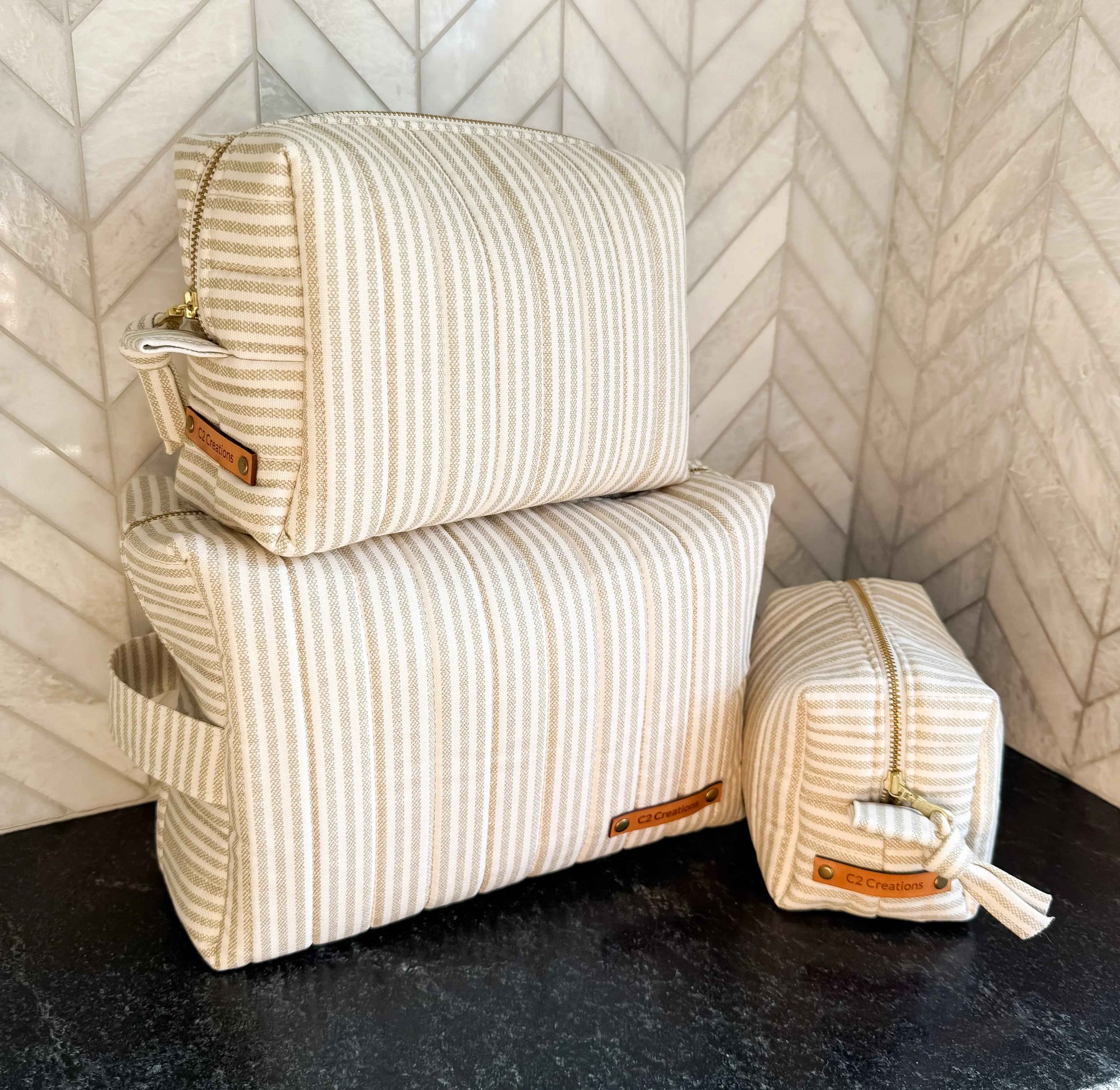 Handmade C2 Creations LLC makeup bag with taupe and cream ticking stripe pattern, boxy toiletry and makeup storage bag.