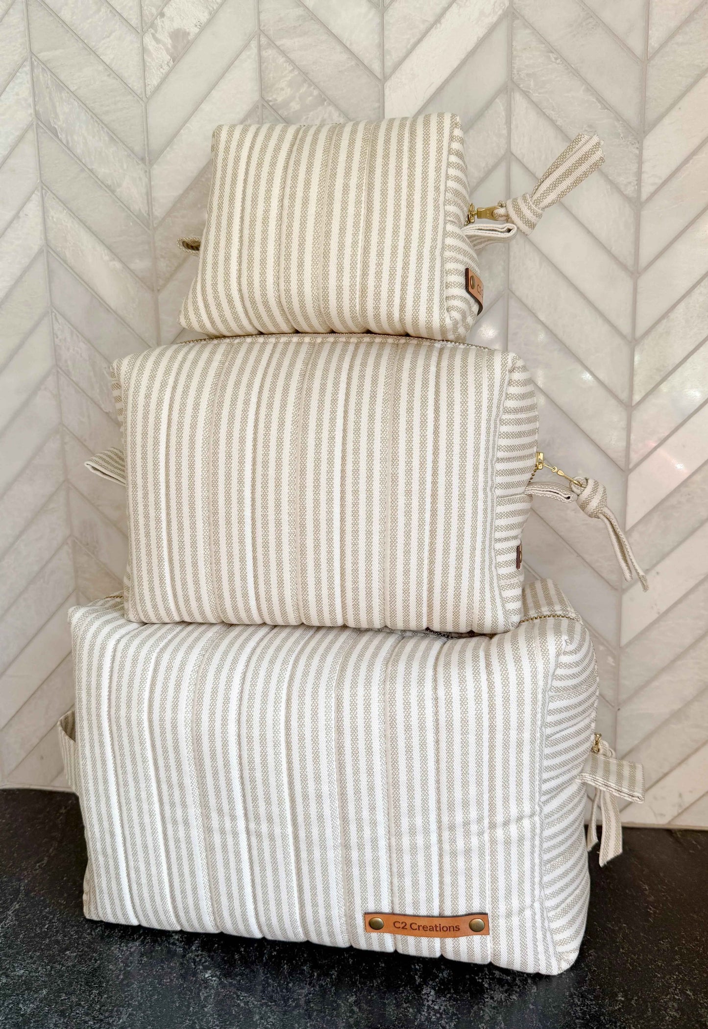 Handmade taupe and cream ticking stripe makeup bag by C2 Creations LLC, featuring a boxy toiletry and makeup storage design.