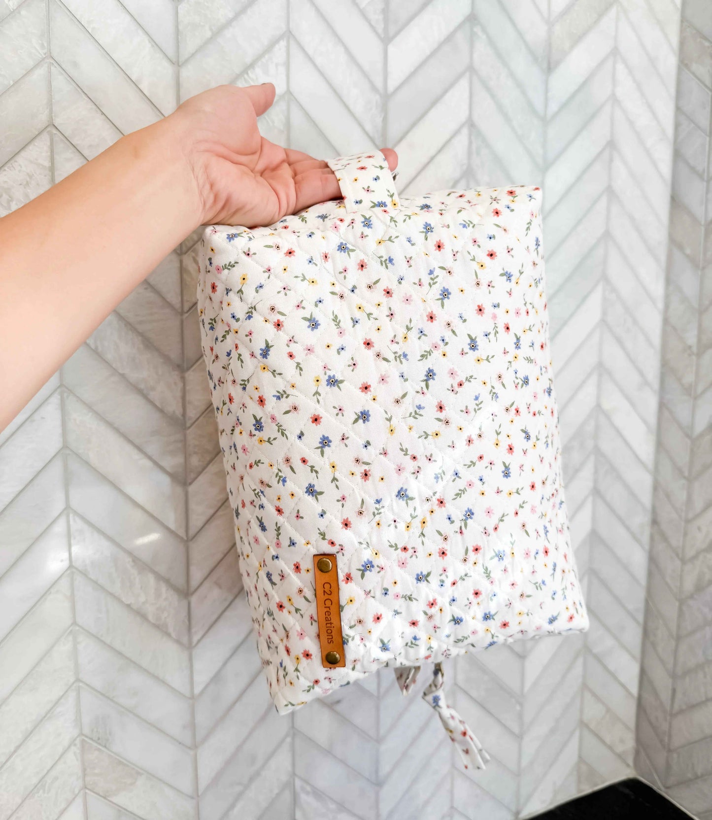 Handmade boxy makeup bag by C2 Creations LLC featuring a wildflower meadow pattern, stylish toiletry storage with zipper closure.