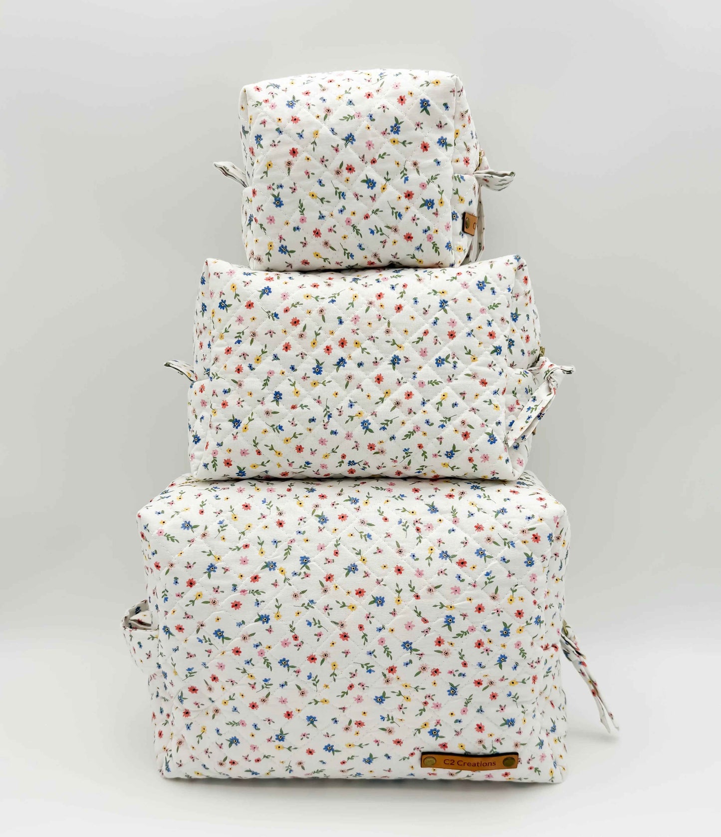 Handmade boxy makeup bag by C2 Creations LLC featuring a colorful wildflower meadow pattern and stylish toiletry storage.