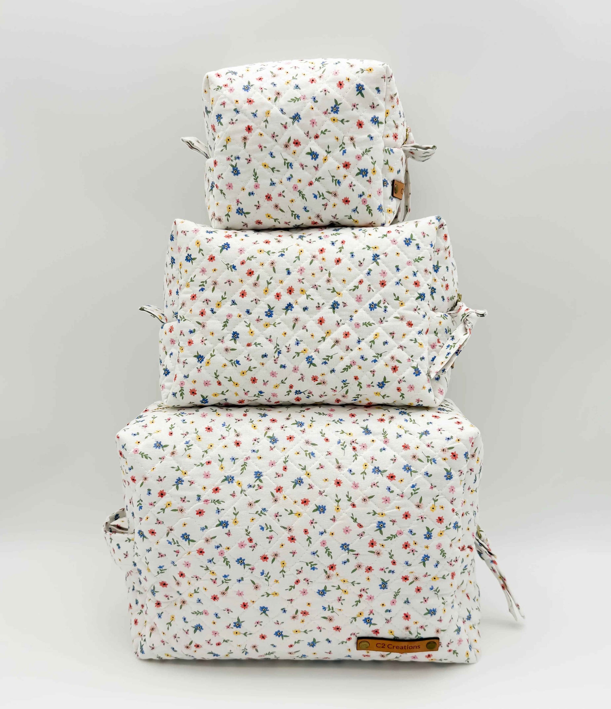Handmade boxy makeup bag by C2 Creations LLC featuring a colorful wildflower meadow pattern and stylish toiletry storage.