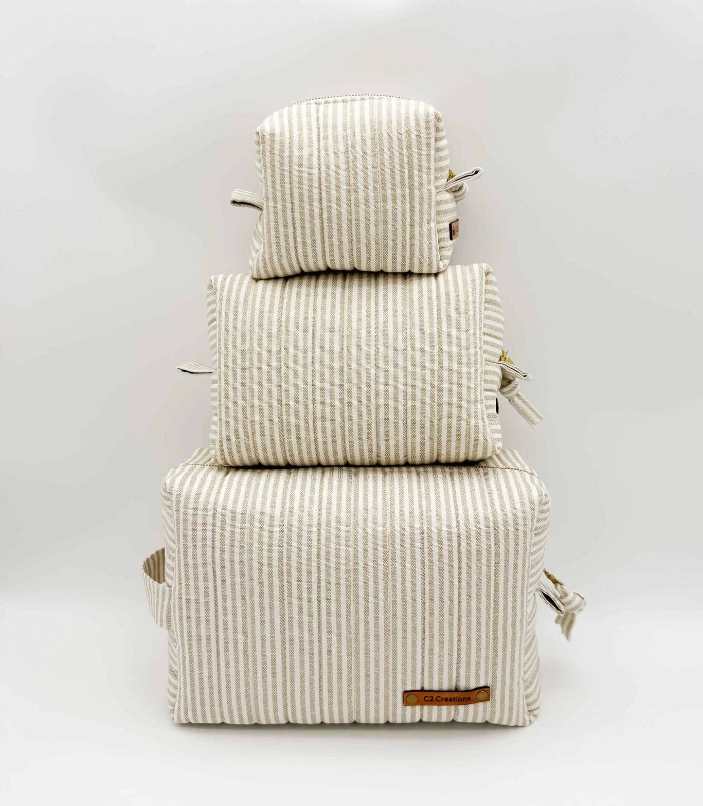 Handmade C2 Creations LLC taupe and cream ticking stripe makeup bag with boxy toiletry design and zip closure.