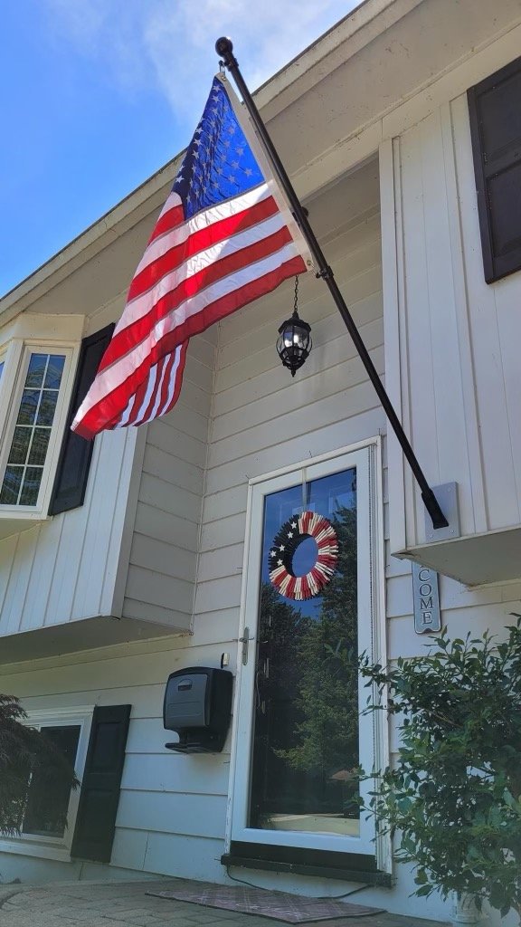 American flag kit by Flagman of America featuring a 2.5' x 4' flag made in the USA, displayed outdoors on a flagpole.