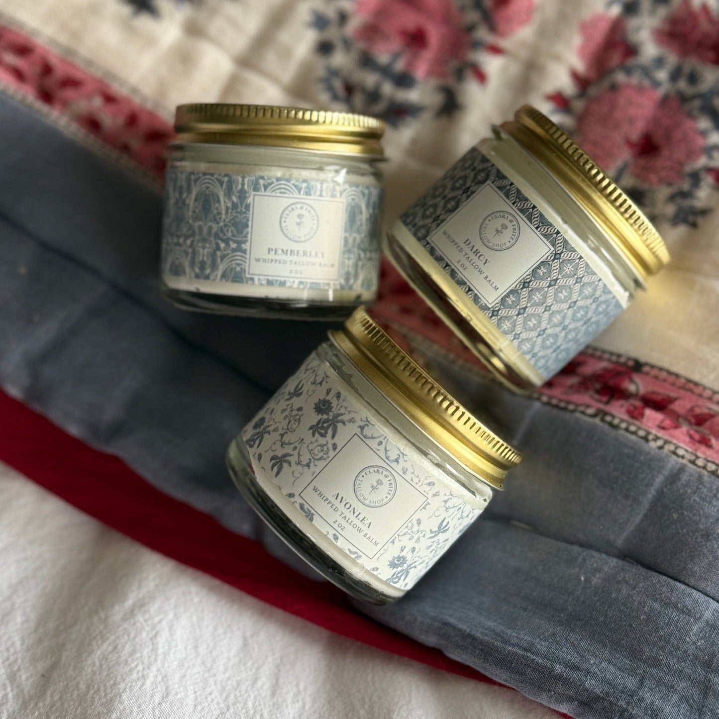 Clara & Fritz Tallow Shop Signature Scent Trio of lotion and moisturizer set with elegant packaging and floral accents.