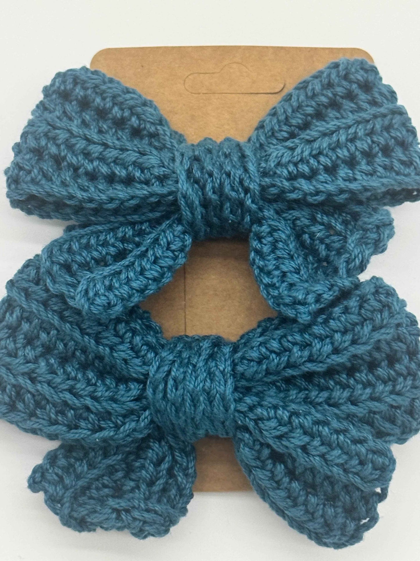 Handcrafted crochet bow hair accessory from C2 Creations LLC, featuring a unique, colorful design for stylish hair decoration.