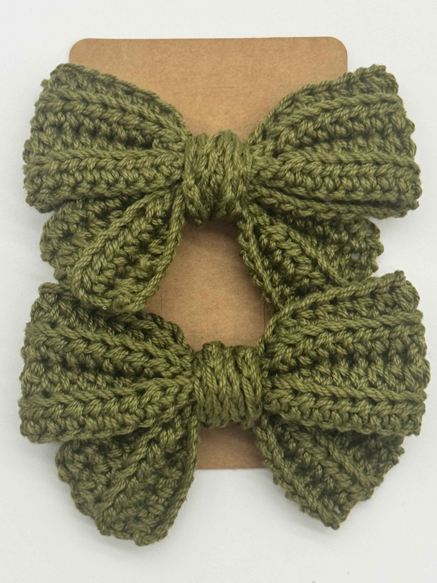 Handcrafted crochet bow hair accessory by C2 Creations LLC, featuring a colorful, textured design for stylish hair decoration.