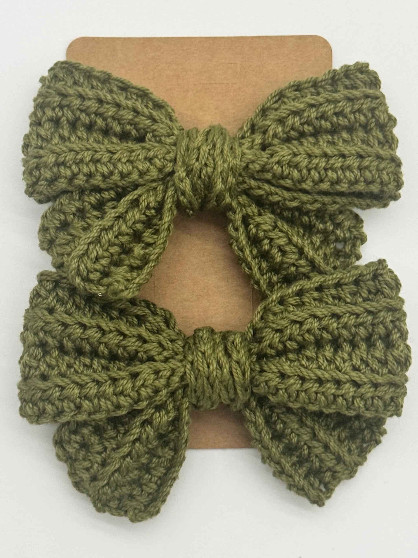 Handcrafted crochet bow hair accessory in pastel colors, designed by C2 Creations LLC for a charming, unique look.