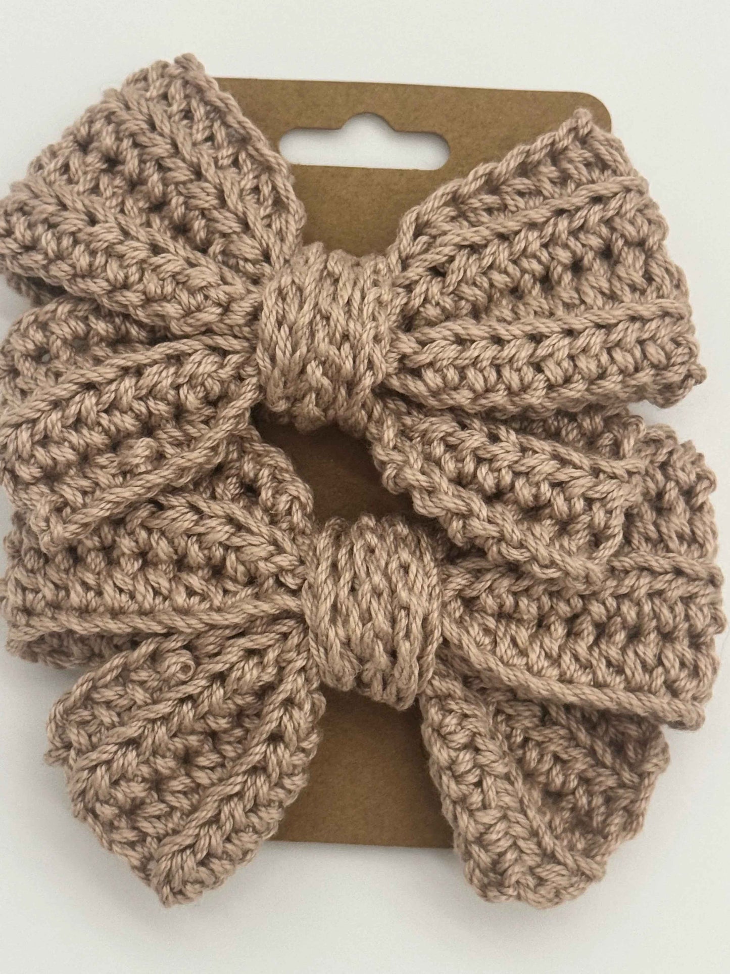 Handcrafted crochet bow hair accessory by C2 Creations LLC, featuring a colorful, textured design for stylish hair decoration.